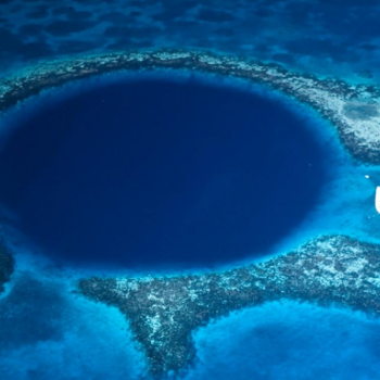 Blue circle of water surrounded by reefs